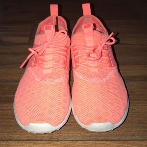 Bright coral Nike running shoes